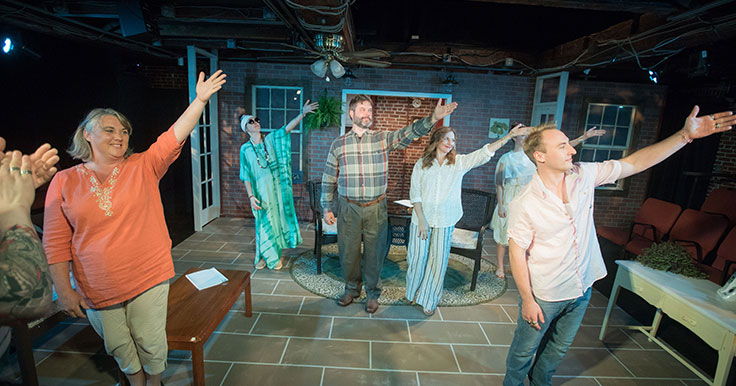 Actors rehearsing on stage together
